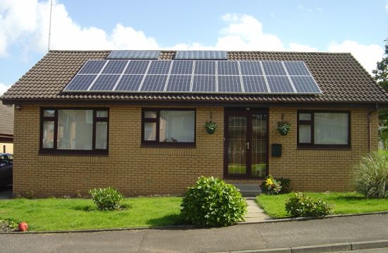 Even modest homes can benefit from rooftop solar. The dual-use panels on this house generate both electricity and heat.